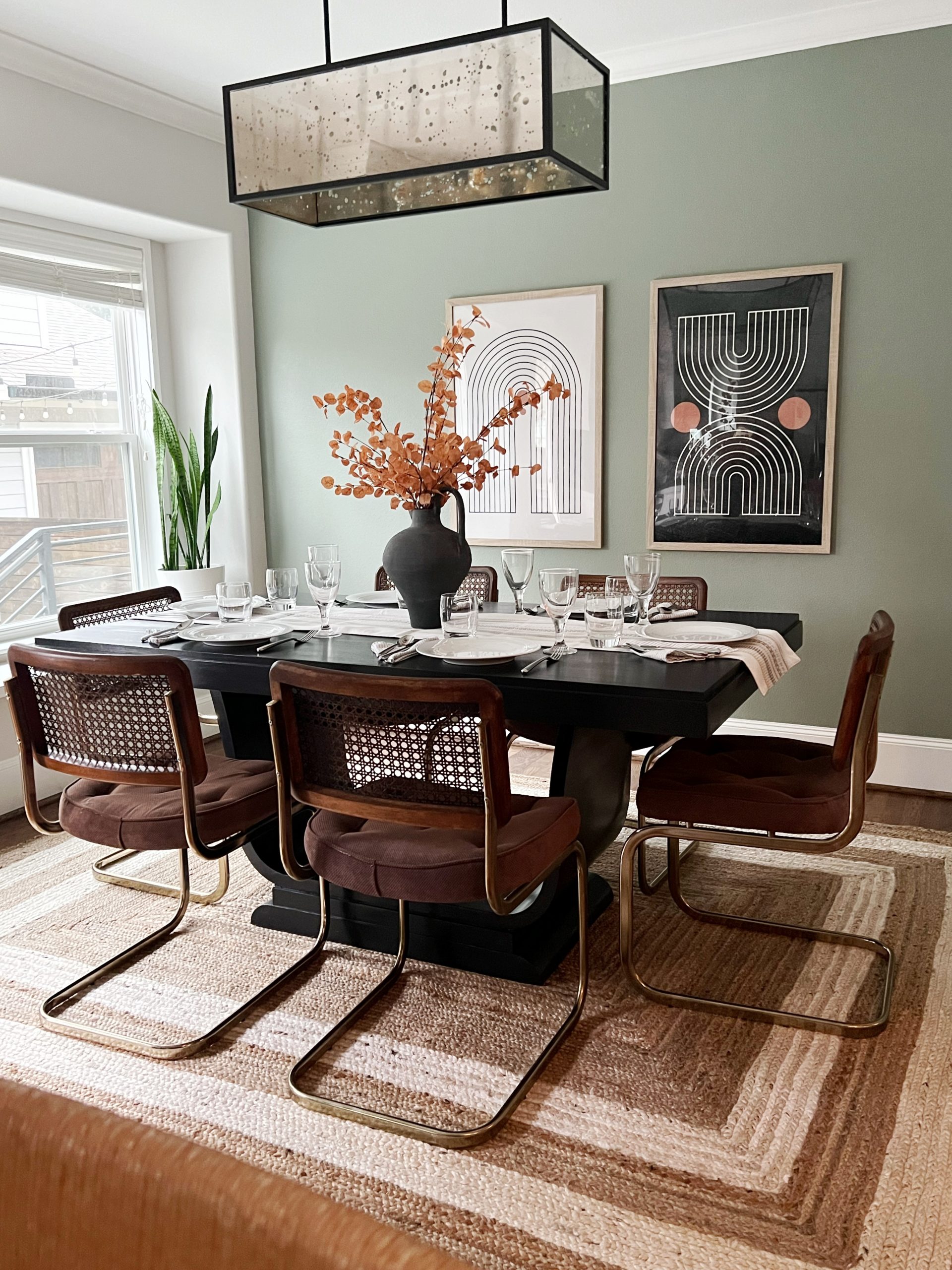 Dining Room with black midcentury modern table and cane cesca chairs
